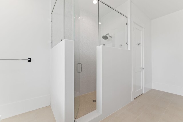 bathroom with walk in shower and tile patterned floors