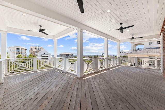 wooden deck with ceiling fan and a residential view