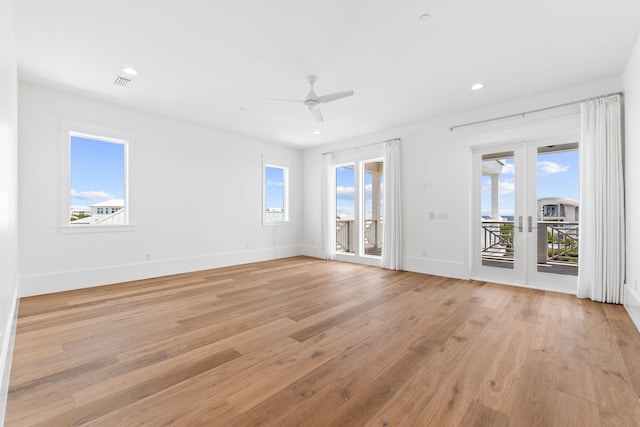 empty room featuring light wood-style flooring, recessed lighting, visible vents, baseboards, and french doors