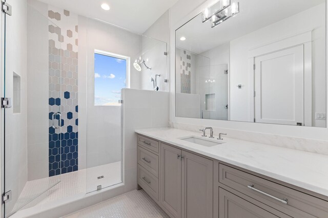 bathroom featuring vanity, walk in shower, and tile patterned floors