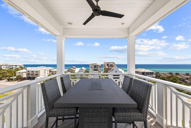 balcony with a water view and ceiling fan