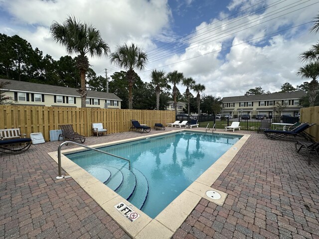 view of swimming pool with a patio area