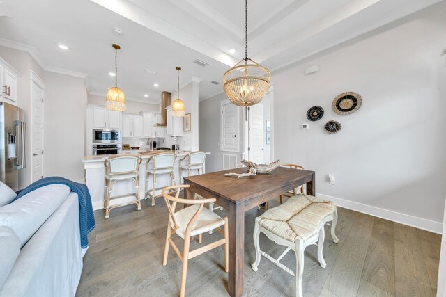 dining area with ornamental molding, dark hardwood / wood-style floors, and a notable chandelier