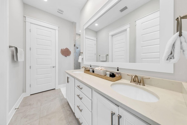 bathroom featuring tile patterned flooring, vanity, and walk in shower