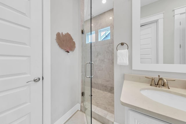 bathroom with vanity and a shower with shower door