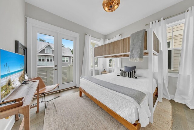 bedroom with light hardwood / wood-style flooring, french doors, and access to outside