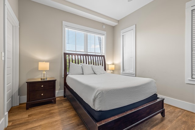 bedroom with baseboards and wood finished floors
