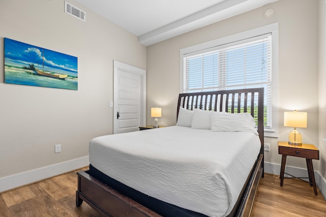 bedroom with wood-type flooring