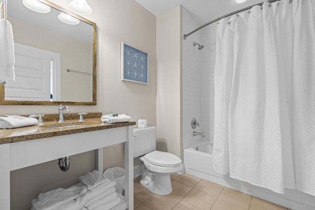 bathroom featuring tile patterned floors, toilet, a sink, and shower / bathtub combination with curtain
