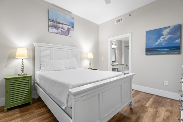 bedroom with connected bathroom, ceiling fan, and dark wood-type flooring