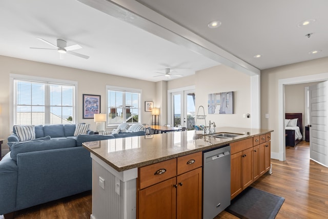 kitchen featuring a ceiling fan, dark wood-type flooring, stone counters, open floor plan, and stainless steel dishwasher