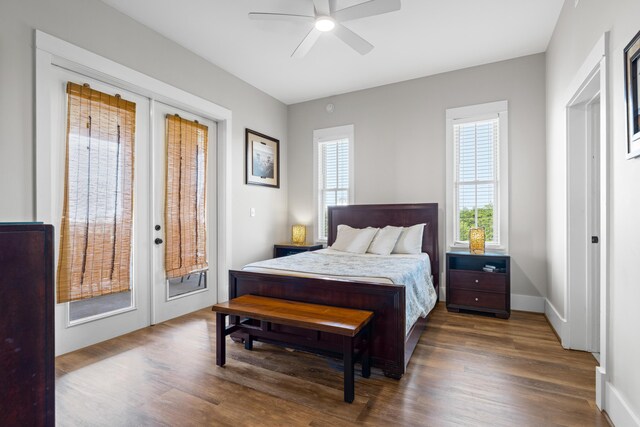 bedroom with ceiling fan, dark wood-type flooring, access to exterior, and french doors