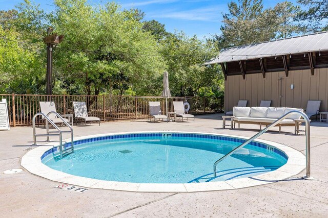 view of swimming pool with a patio and an outdoor living space