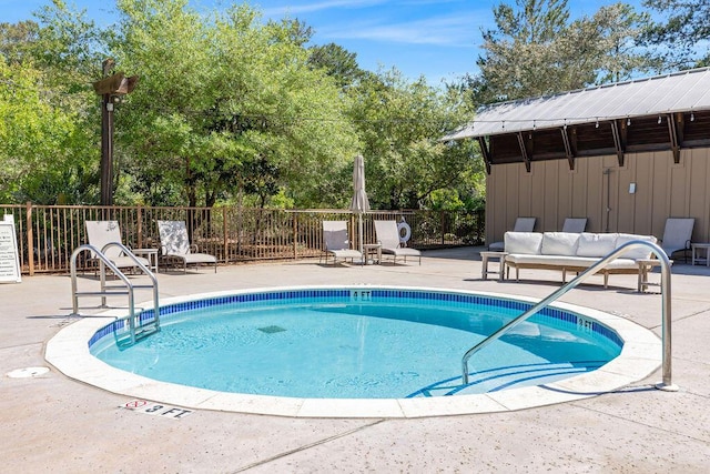 view of pool featuring fence and a patio area