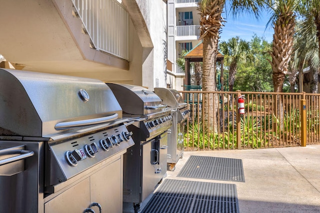 view of patio featuring area for grilling and a balcony