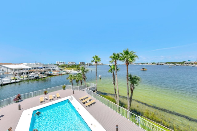 view of pool featuring a patio and a water view