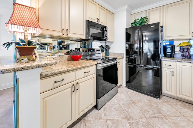 kitchen featuring crown molding, cream cabinets, light stone counters, and black appliances