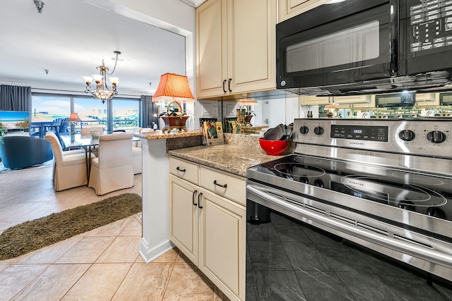 kitchen with tasteful backsplash, a notable chandelier, electric range, light stone countertops, and cream cabinetry