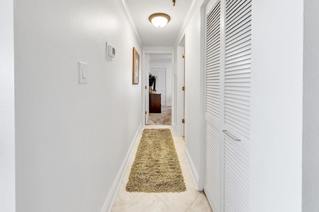 corridor with ornamental molding and light tile patterned floors