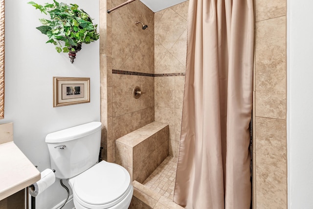 bathroom featuring vanity, toilet, and walk in shower