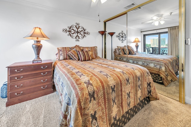 carpeted bedroom featuring access to exterior, crown molding, a closet, and ceiling fan