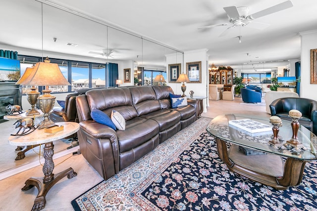 living room with ornamental molding and ceiling fan