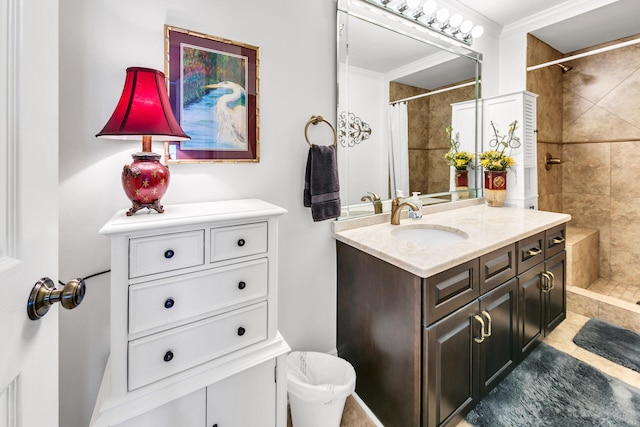 bathroom featuring vanity, crown molding, and walk in shower