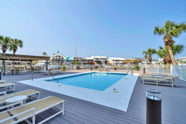 view of pool featuring a pergola and a deck