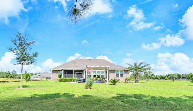 back of property featuring a pergola and a yard