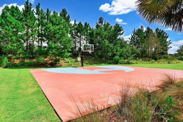 view of sport court featuring a lawn