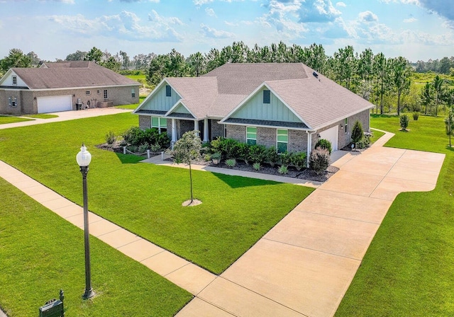 craftsman house with a garage and a front yard