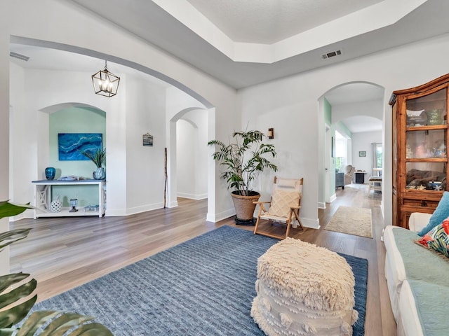 living room featuring hardwood / wood-style flooring and a notable chandelier