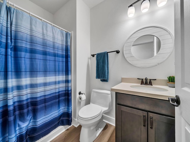 bathroom with vanity, hardwood / wood-style floors, and toilet