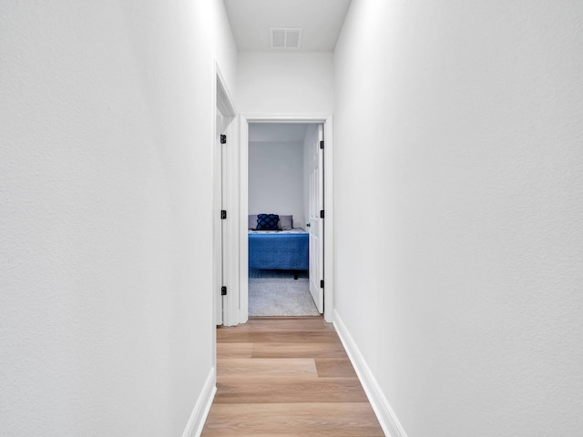 corridor featuring light hardwood / wood-style floors