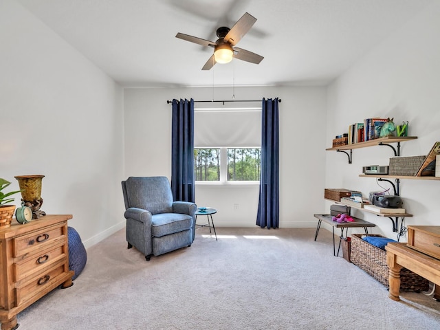 living area featuring ceiling fan and light colored carpet