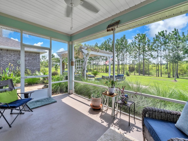 sunroom / solarium featuring ceiling fan