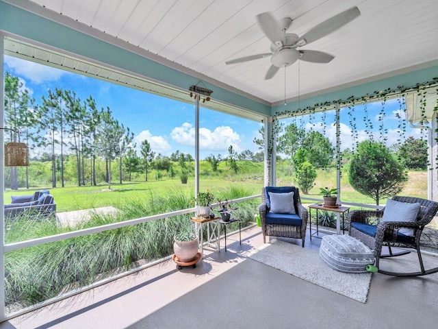 sunroom / solarium featuring ceiling fan