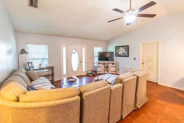 living room featuring ceiling fan, lofted ceiling, and tile patterned floors