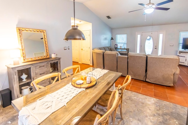 dining space featuring tile patterned flooring, vaulted ceiling, and ceiling fan