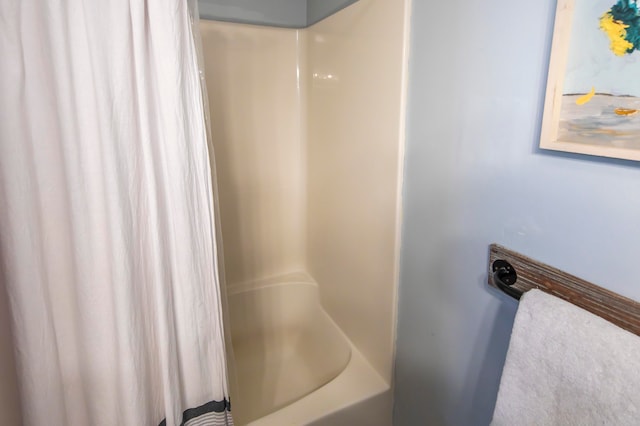 bathroom with shower / bath combination with curtain