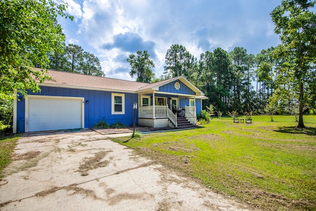 ranch-style home with a front yard, a garage, and covered porch