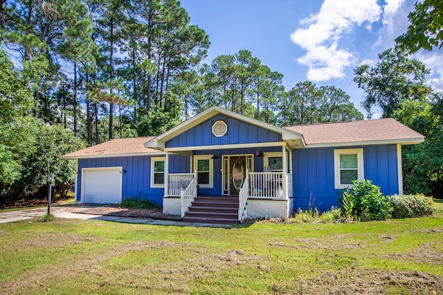 single story home with a front yard, a porch, and a garage