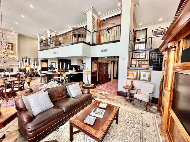 tiled living room with a towering ceiling, a notable chandelier, and ornamental molding