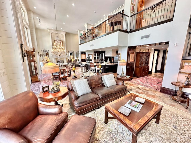 tiled living room with a towering ceiling and a chandelier