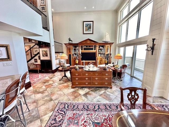 living room featuring ornamental molding and a high ceiling