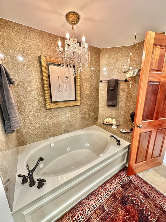 bathroom featuring an inviting chandelier, a bath, and tile patterned flooring