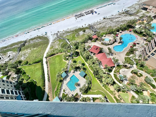 birds eye view of property with a water view and a view of the beach