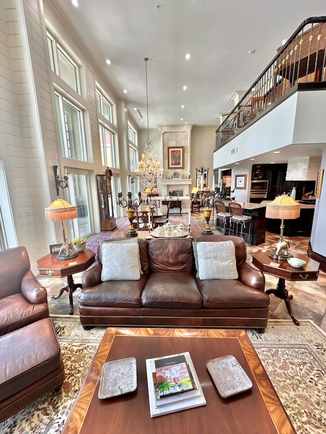 living room featuring a towering ceiling and a chandelier