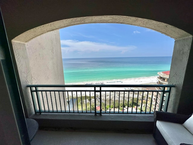 balcony featuring a water view and a beach view