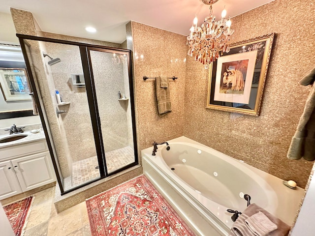 bathroom with vanity, shower with separate bathtub, and an inviting chandelier